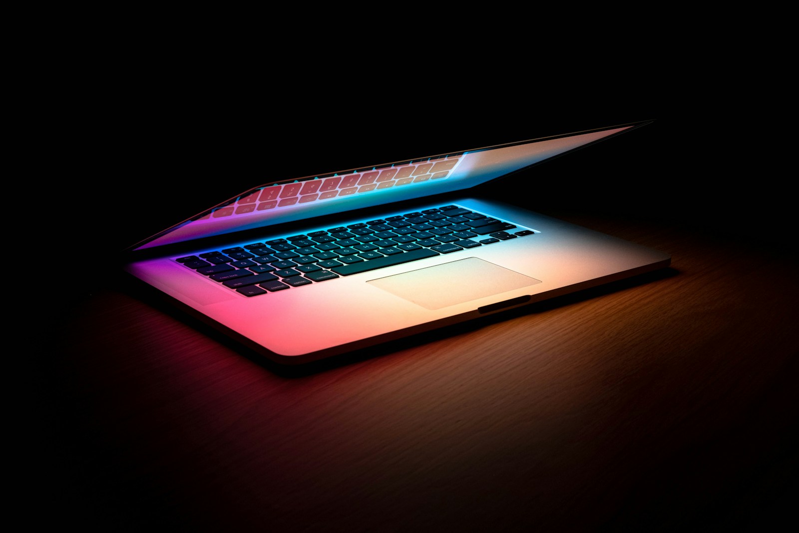macbook pro on brown wooden table